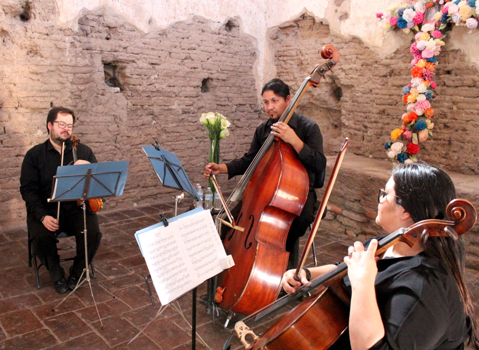 Festival Kino occurs annually in May with activities in both Arizona and Sonora. string trio in church with flowers