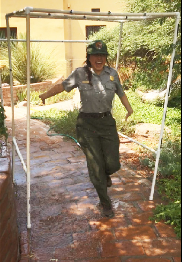 ranger running through sprinkler