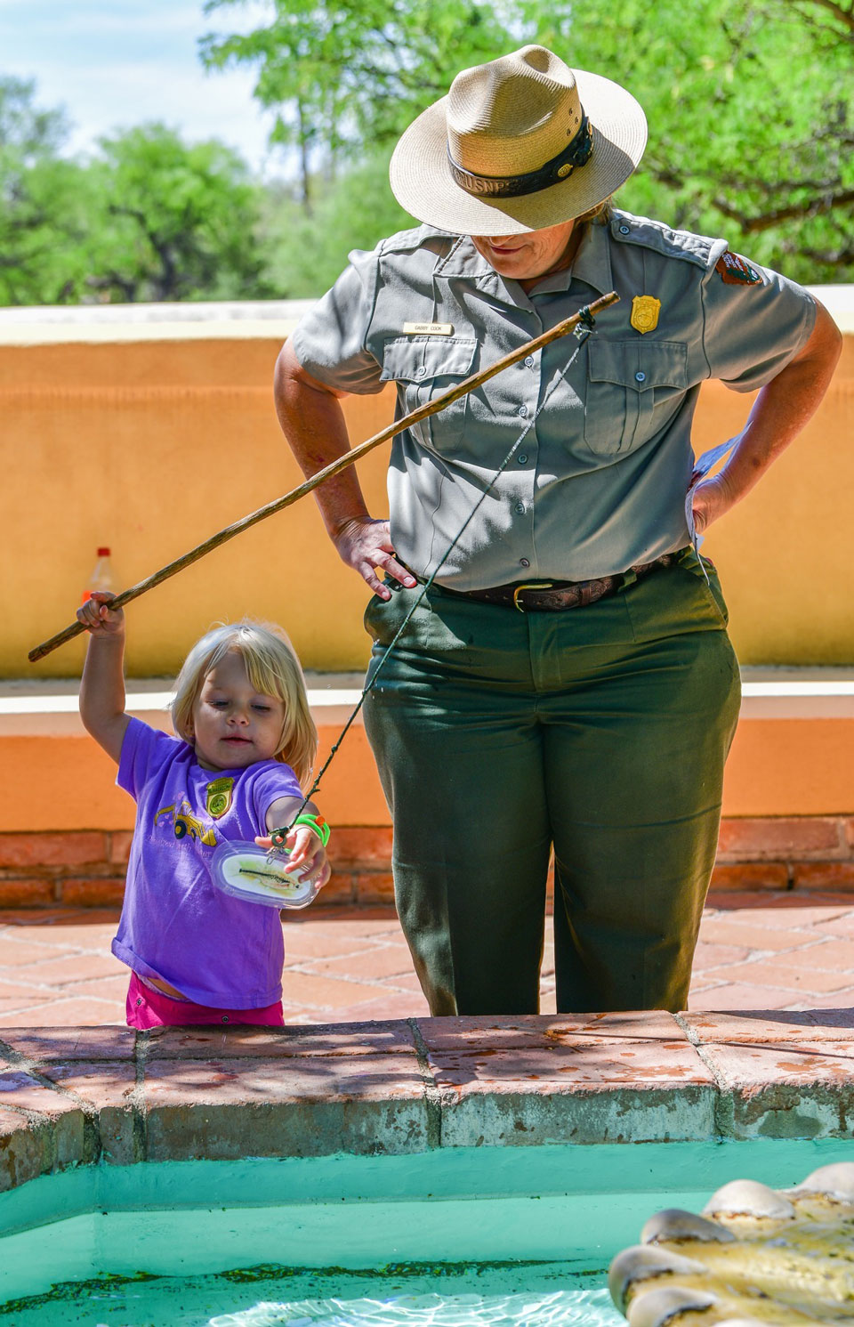 fishing for gila topminnow girl and ranger at fountain with finish pole