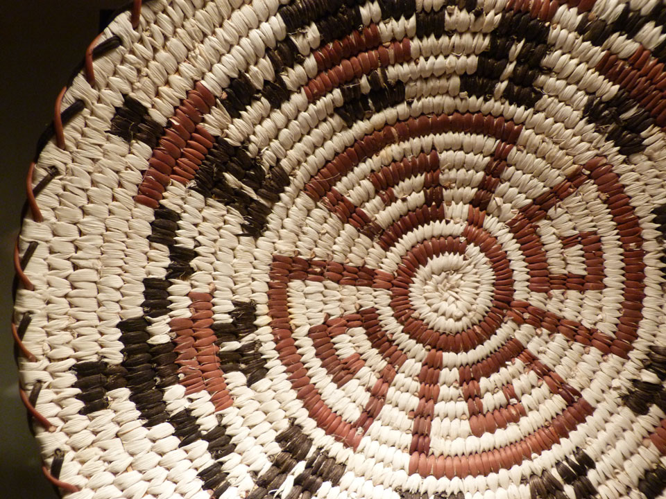 close up of basket woven with figures holding hands