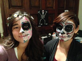 two young women with faces painted as skeletons