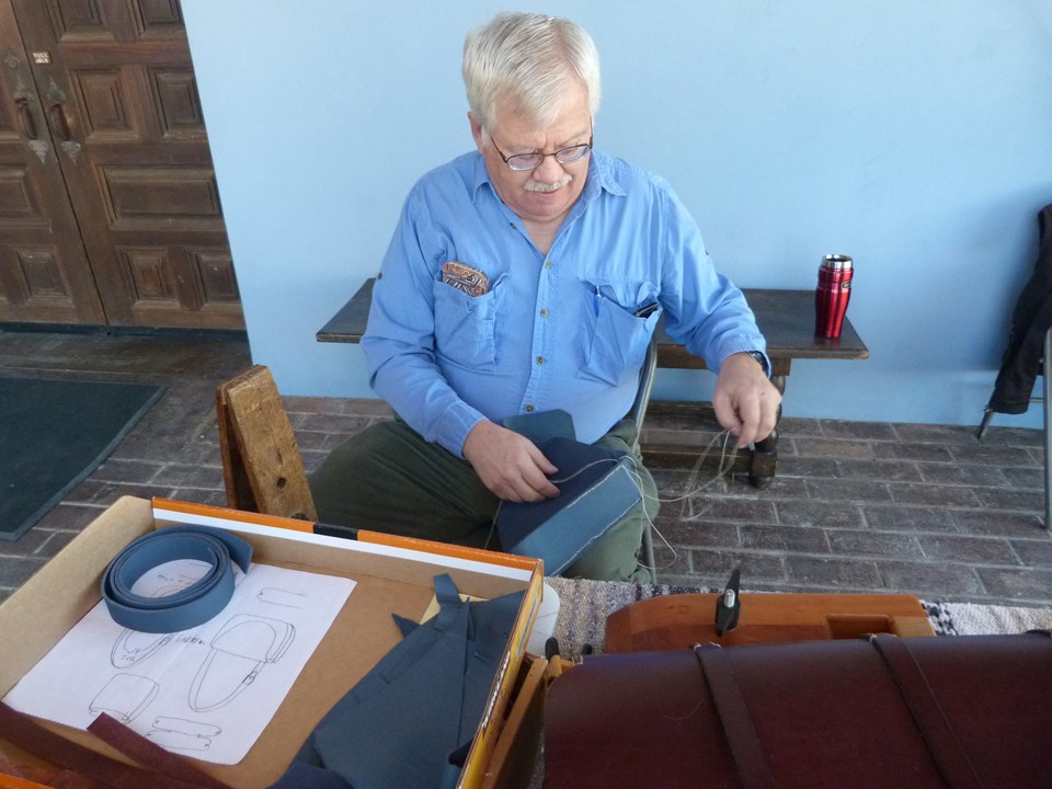 Demonstrator with leather crafts.
