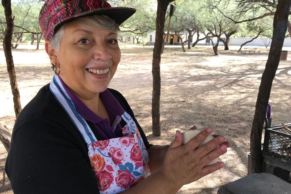 Olinda Gonzalez, tortilla demonstrator, at outdoor kitchen.