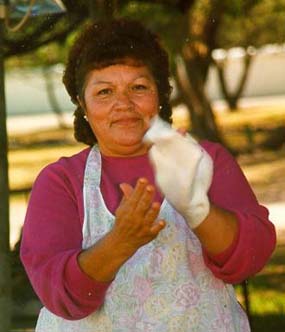 woman stretches masa between her hands for flour tortilla woman stretches masa between her hands for flour tortilla
