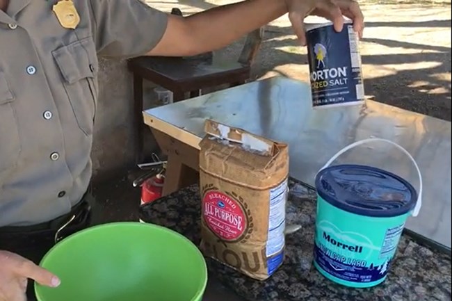 bag of flour, tub of lard, canister of salt, and large bowl