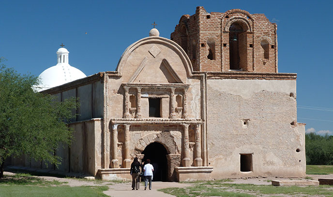 two visitors walking to entrance of church