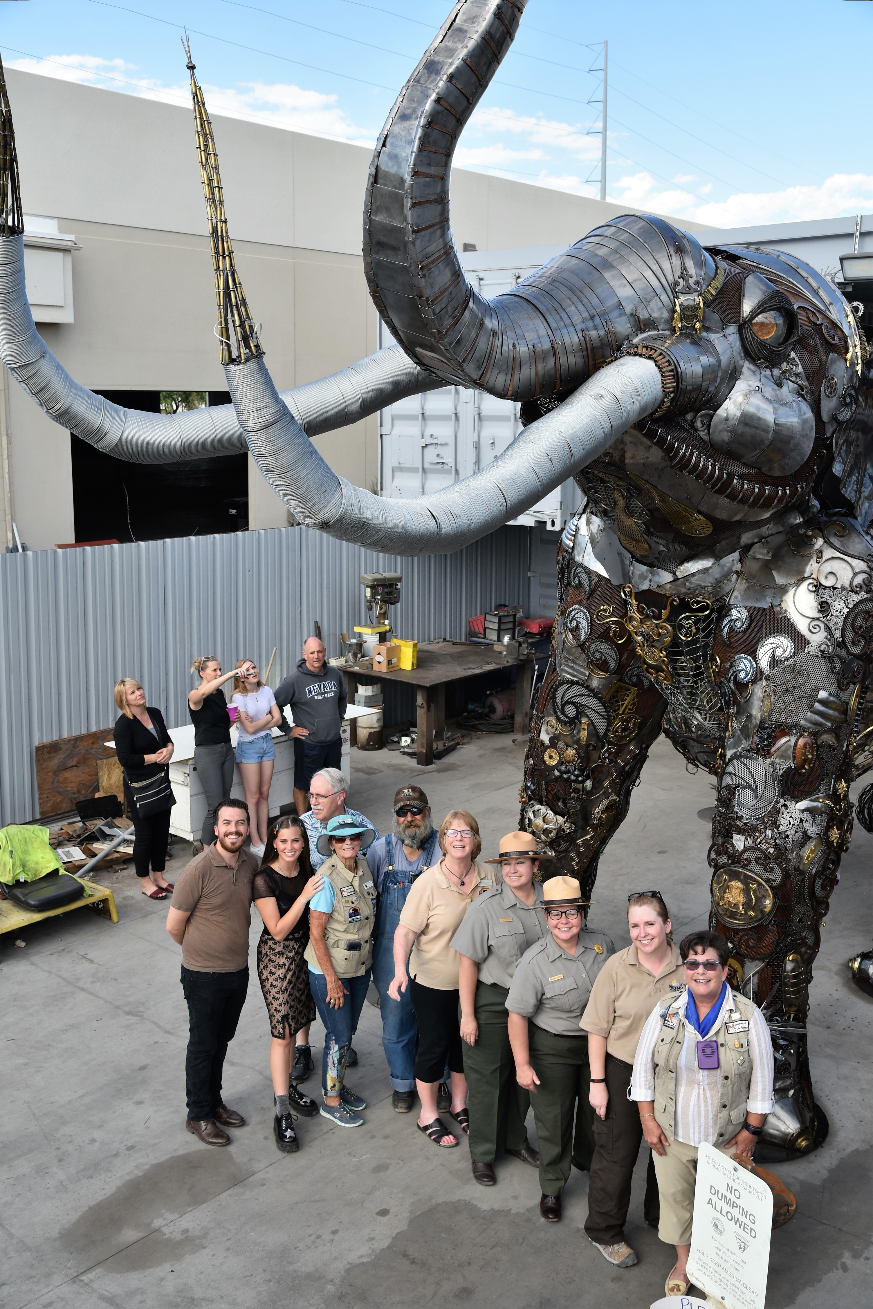 group stands by mammoth sculpture