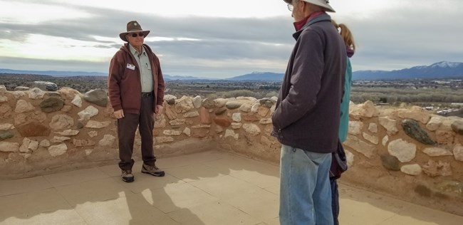 Volunteer speaks with visitors