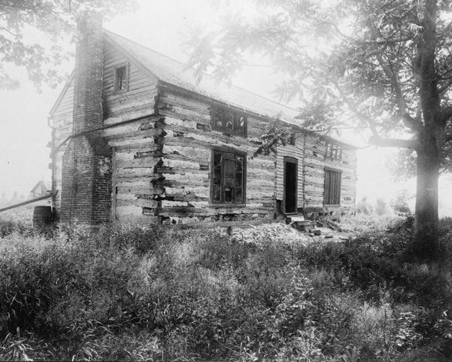 Grant's Cabin "Hardscrabble" Black and white photograph of a two-story log cabin.