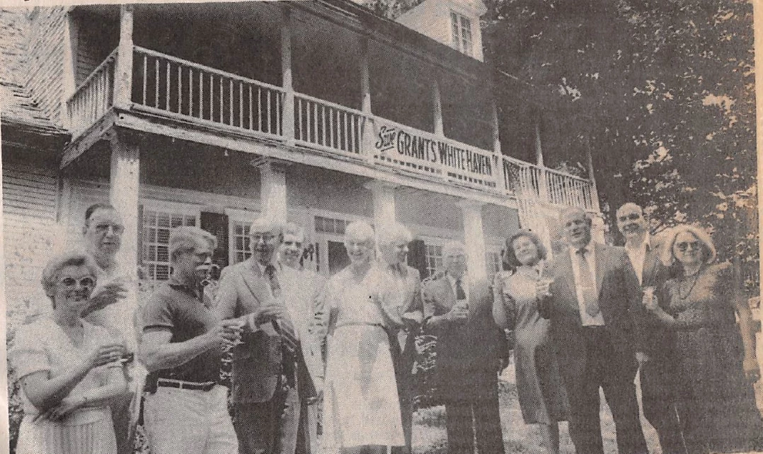 Save Grants White Haven Members, July 1986 Black and white photo of a men and women toasting in front of the White Haven home.