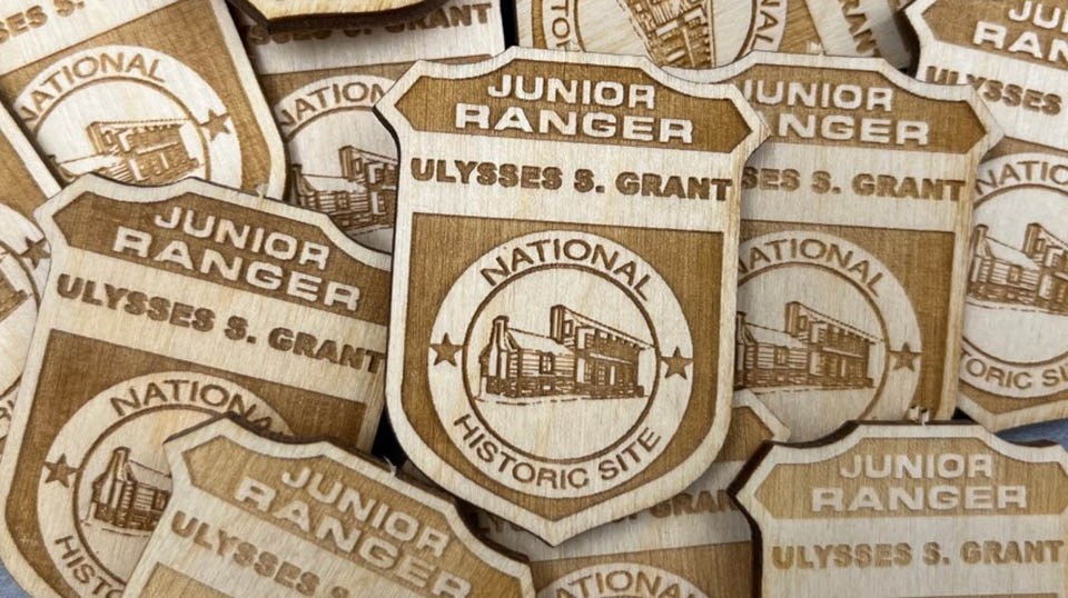 Pile of ULSG junior ranger wooden badges