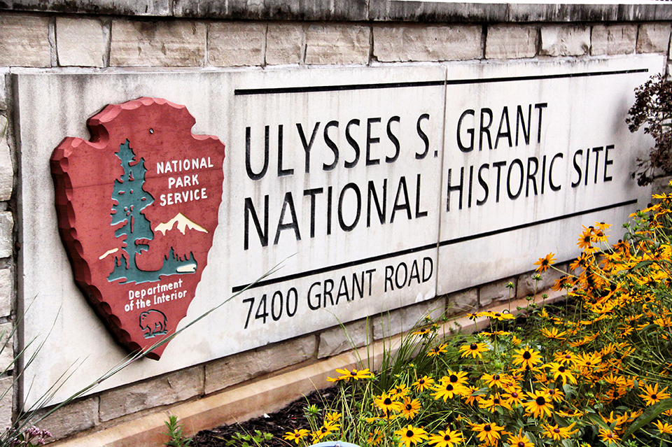 Entrance sign at Ulysses S. Grant National Historic Site White stone entrance sign for Ulysses S. Grant National Historic Site with yellow flowers
