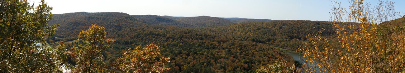 panoramaic image of view of forested hills and delaware river winding around hills at Jensen's Ledges