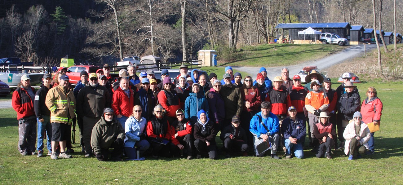 group of people in helmets and wet gear smiling
