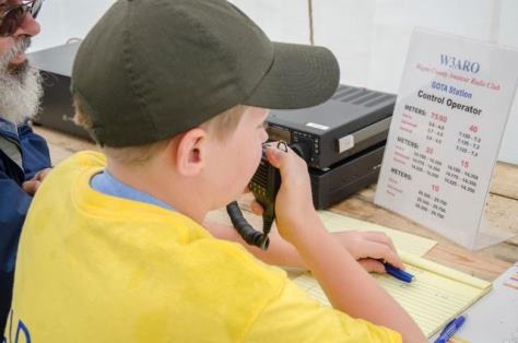 A young visitor learning how to operate a HAM radio.