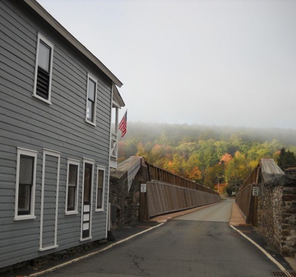 The Toll House above and looking down the roadbed of the Roebling Bridge.