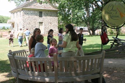 Once upon a nation storyteller with visitors near Washington's Headquarters Once upon a nation storyteller with visitors near Washington's Headquarters