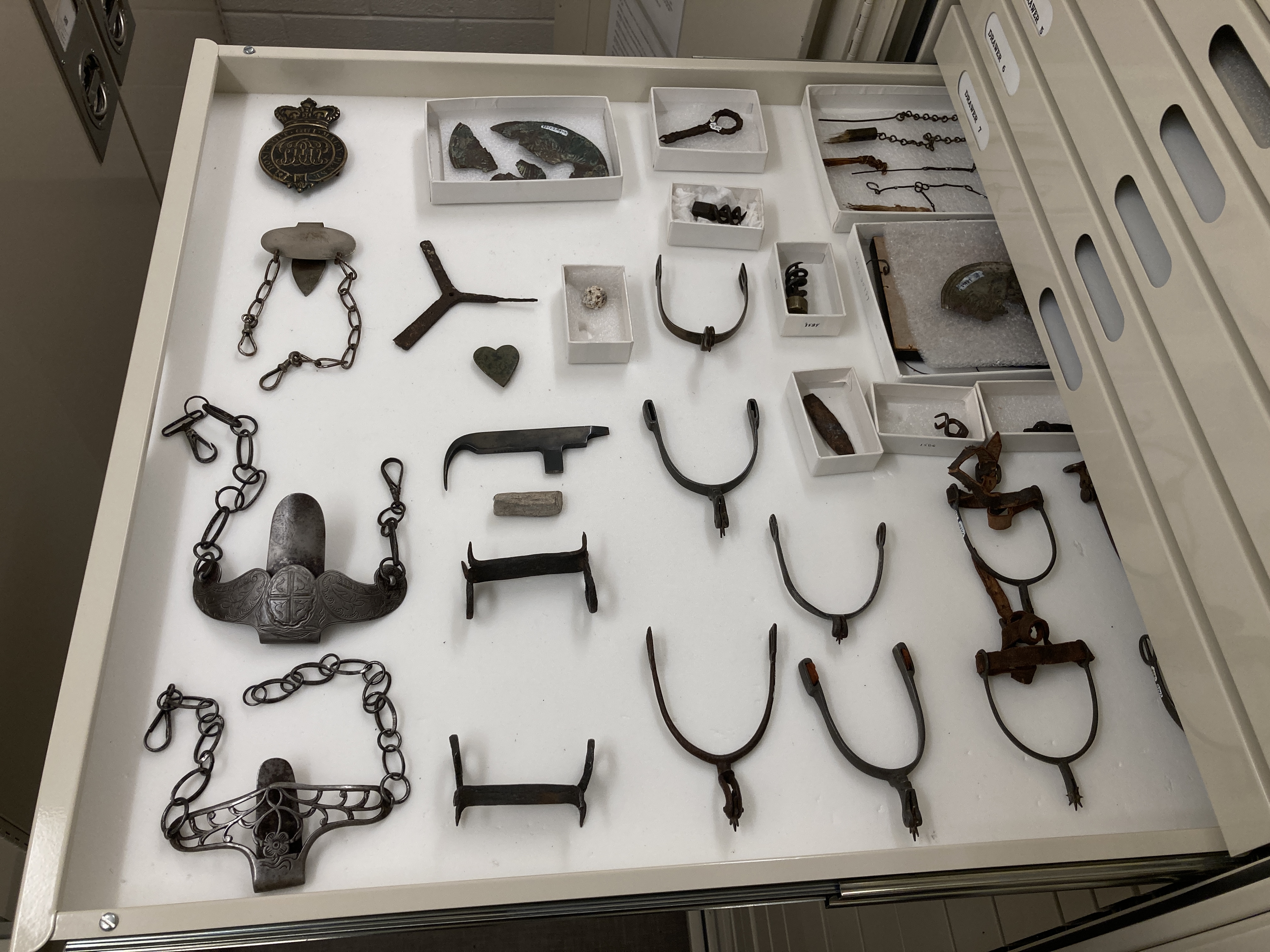 metal objects sit in a shallow open drawer