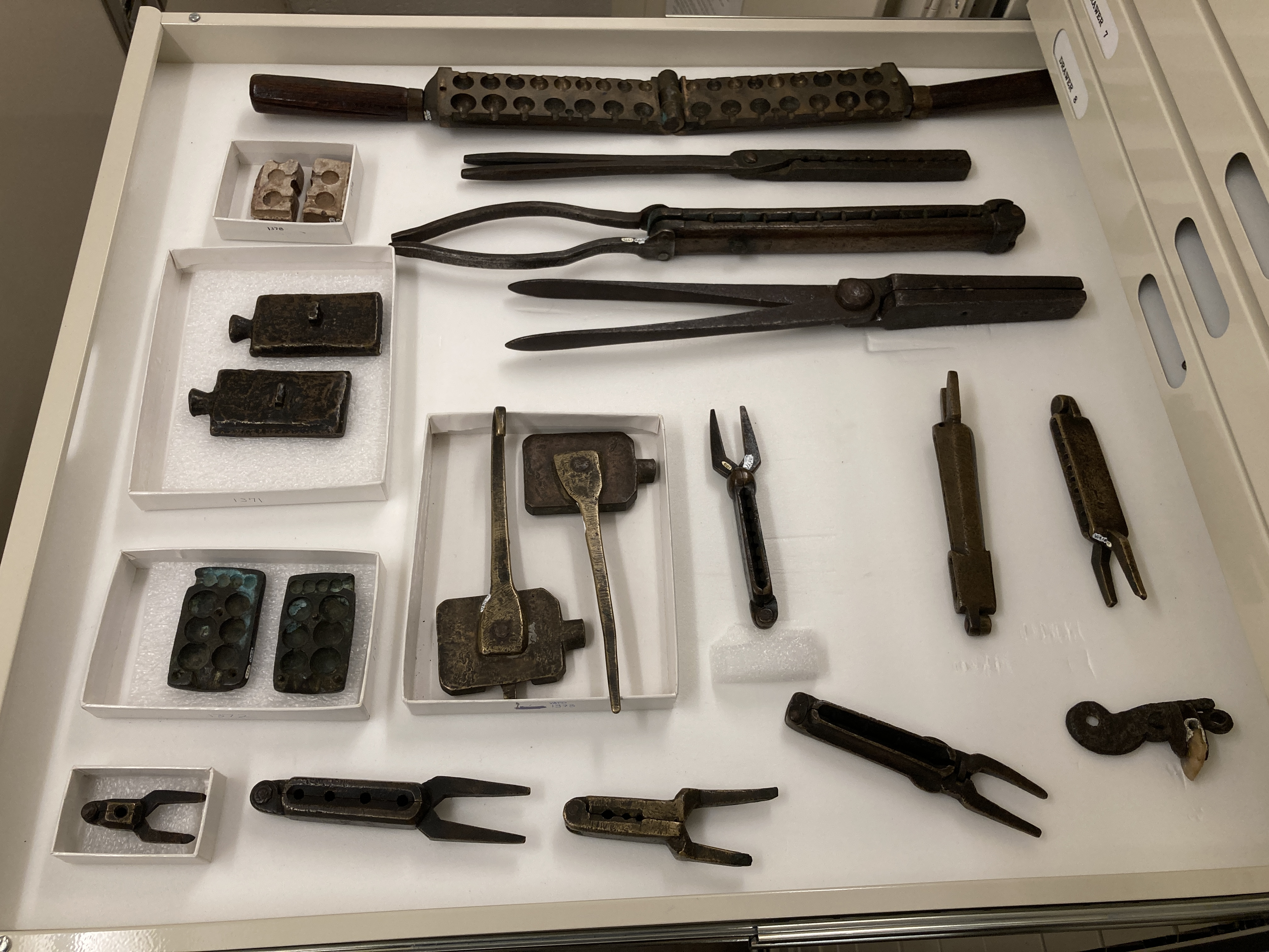 metal objects sit in a shallow open drawer