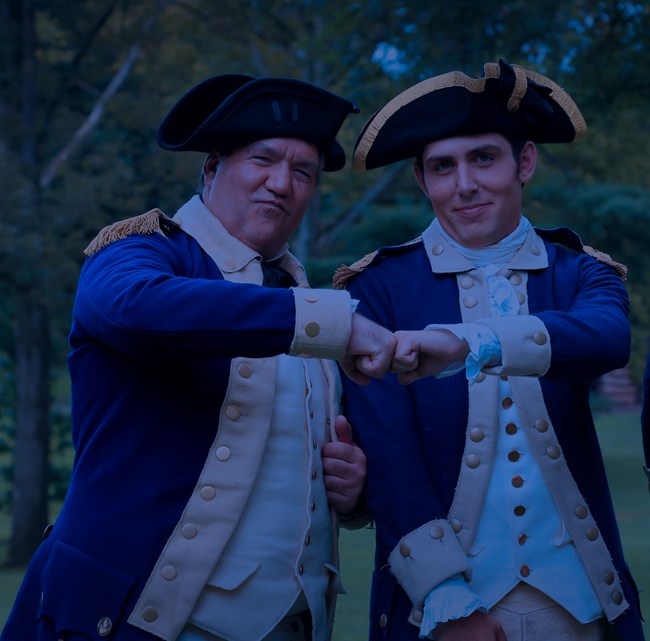 outdoors, soldiers, smiles, fist bump