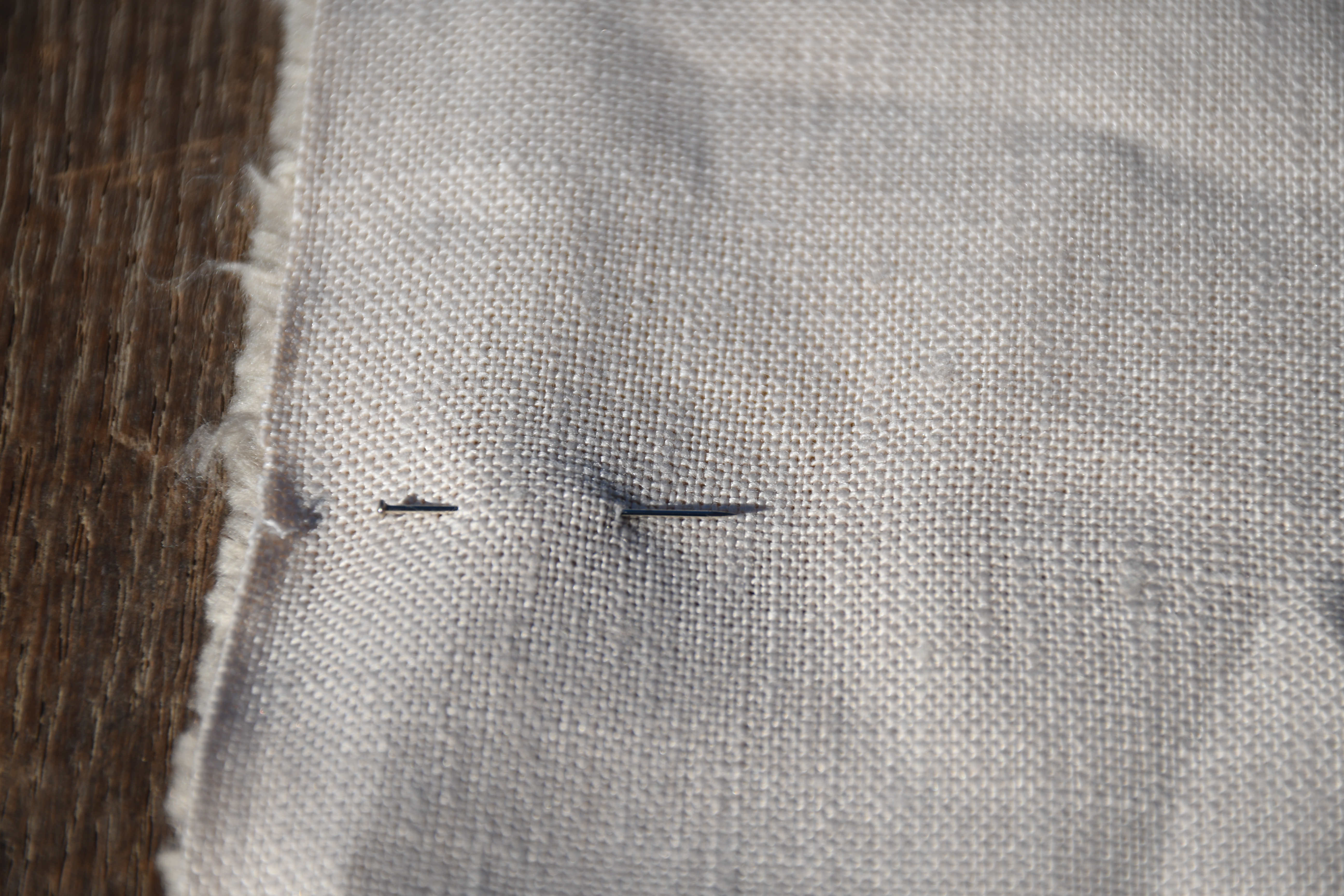 photograph, outdoors, closeup of pin sitting neatly inserted into fabric
