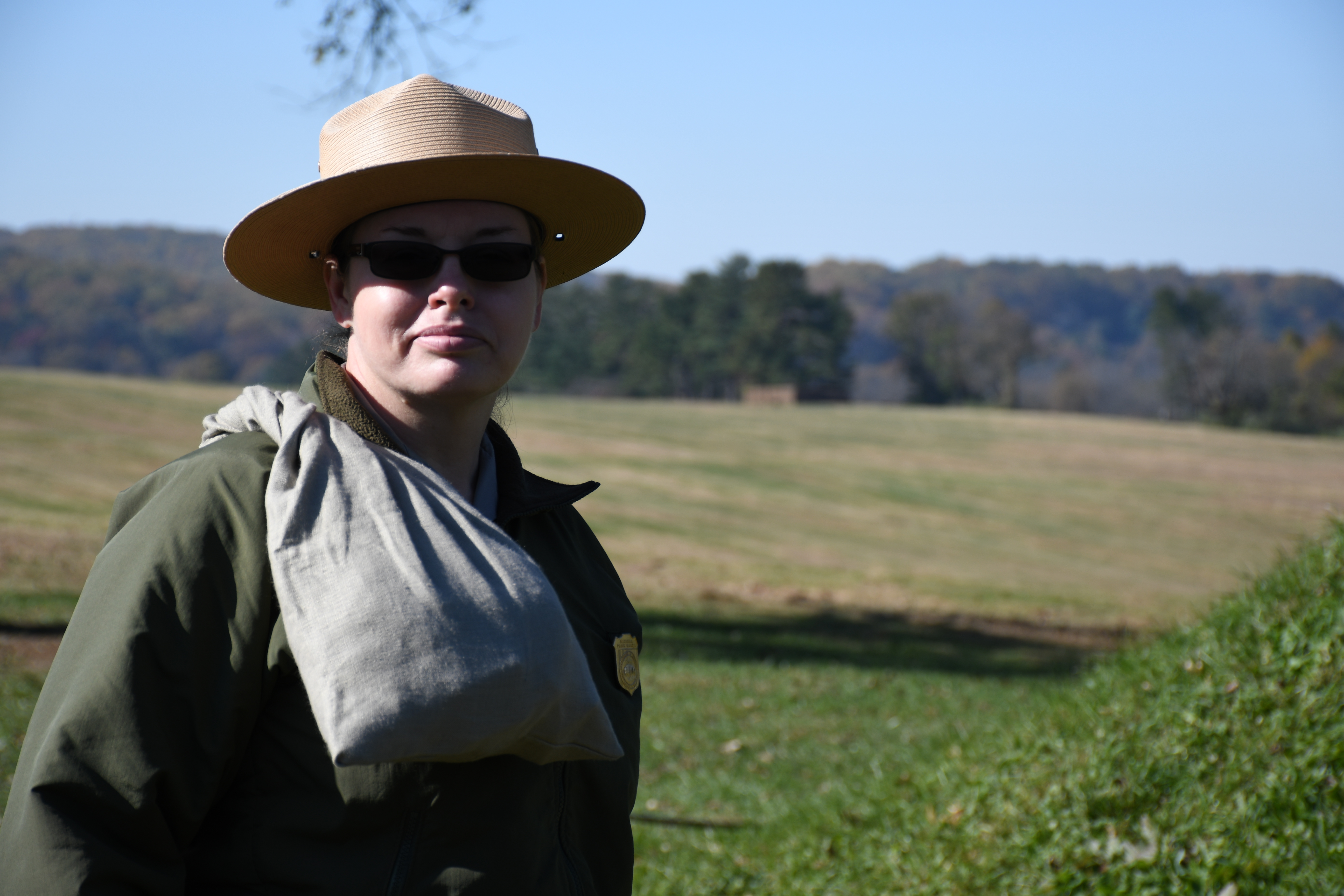 photograph, outdoors, a uniform park ranger carries a completed market wallet on her soldier 