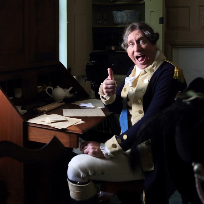 indoors, writing desk, thumbs up