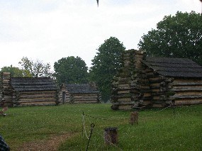 Rain falls onto huts built at the location of Muhlenberg's brigade.