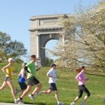 Runners in front of Arch
