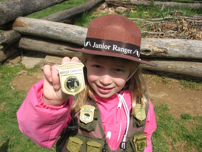 Junior Ranger girl shows off her many park badges and patches Junior Ranger girl shows off her many park badges and patches
