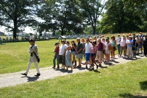 Soldier and visitors marching out of Valley Forge Soldier and visitors marching out of Valley Forge