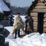 Soldiers in front of a hut in winter