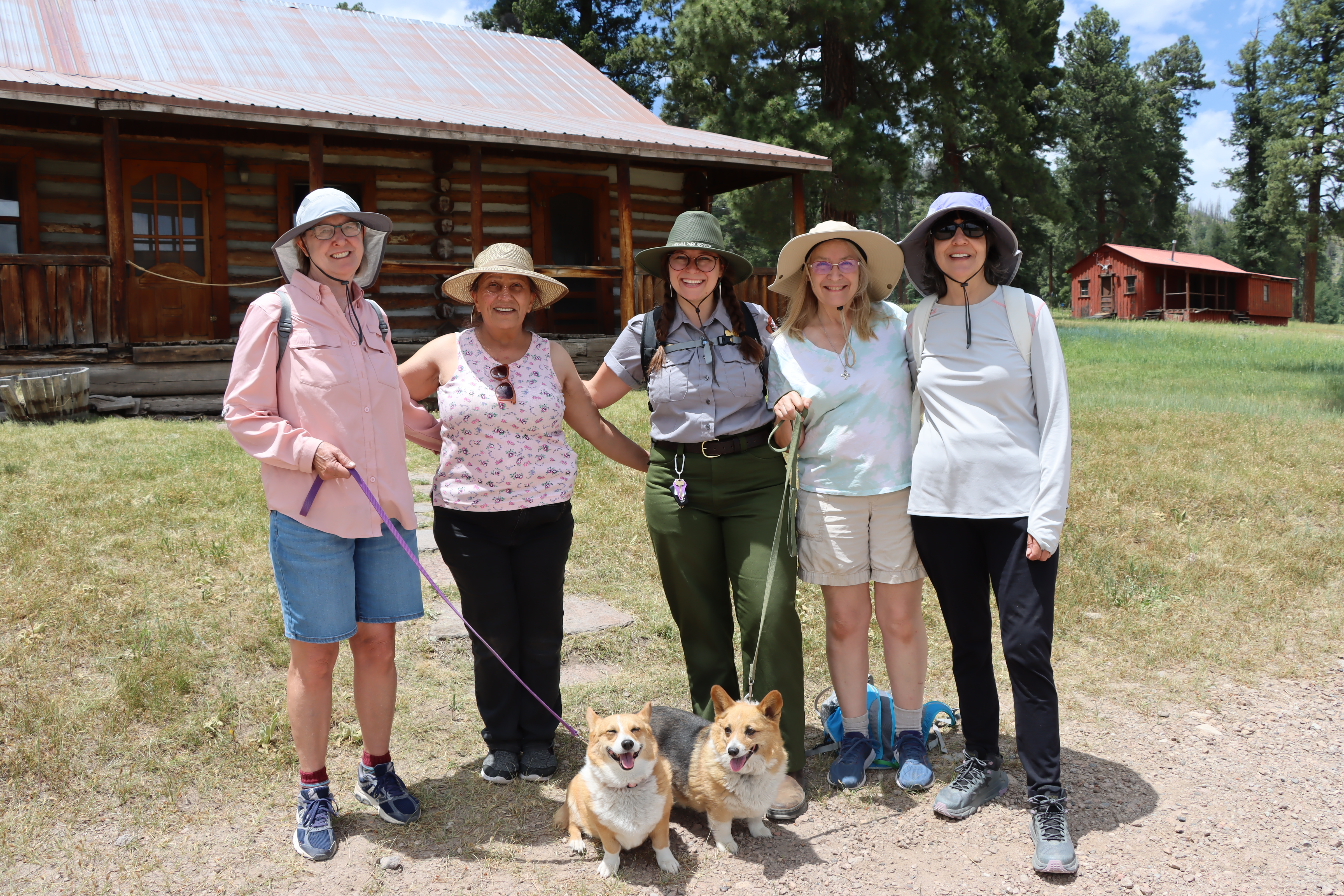 Cabin District Tour 2023 Visitors and their dogs enjoy a guided program with a ranger