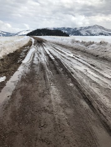 Valles Caldera Entrance Road Muddy Muddy entrance road under a cloudy sky.