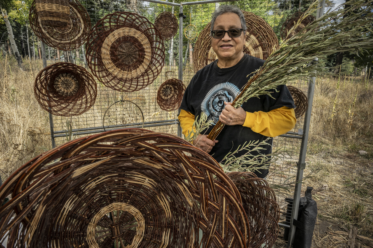 Basket weaver at fall fiesta 2024 Basketweaver showing some of his willow baskets to park visitors.