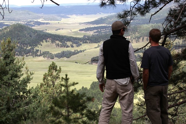 Two hikers looking out over the valles. Two hikers looking out over the valles.