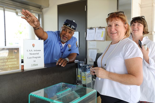 Volunteer Tony Stewart assists guests at the visitor center ticket desk.