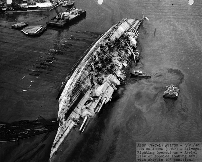 USS Oklahoma being righted in Pearl Harbor