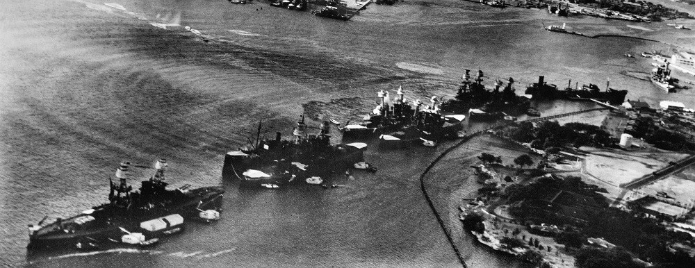 Battleship Row at the start of the Pearl Harbor attack; the mooring quays can be seen near the battleships.