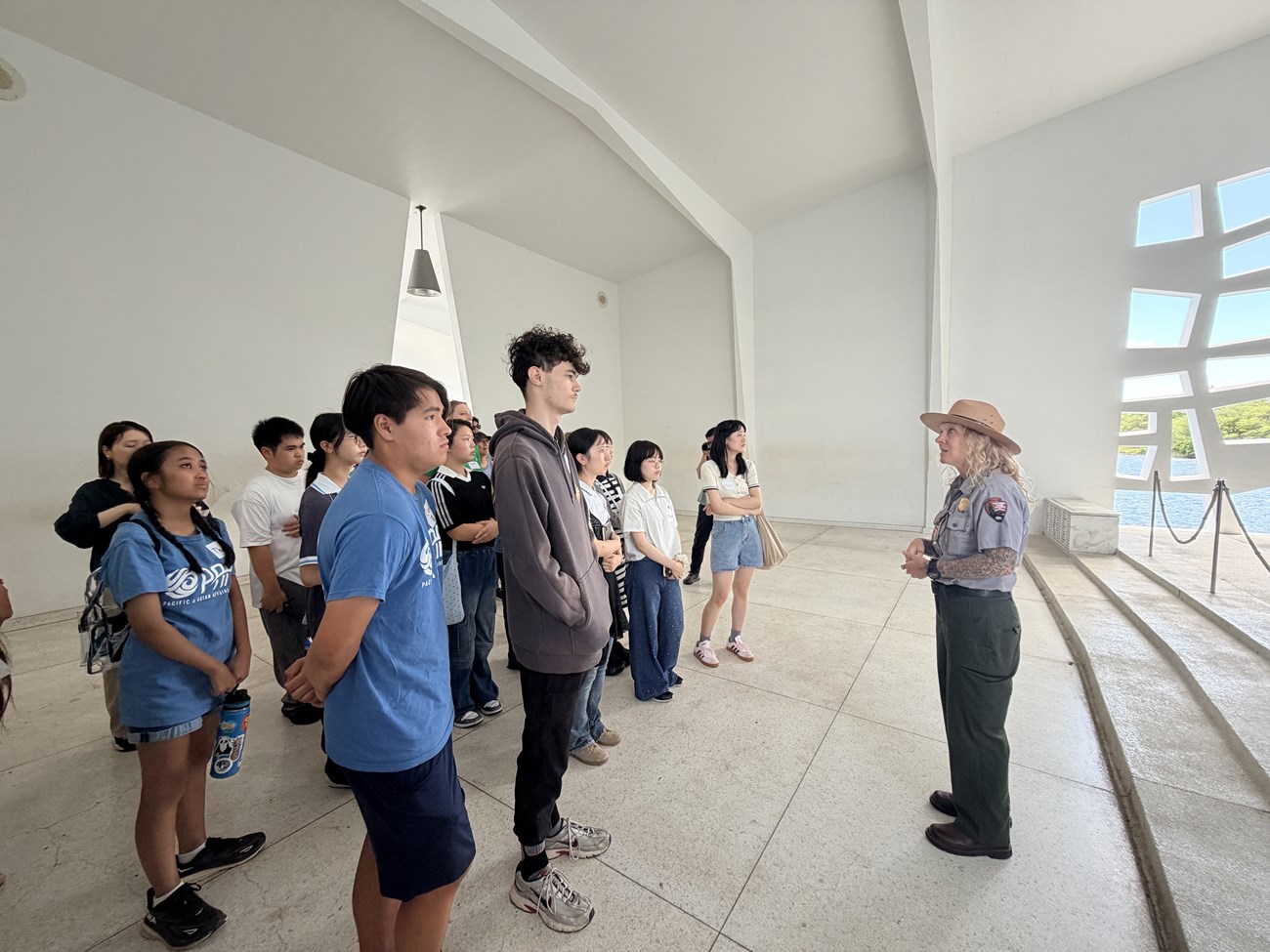 A National Park Service ranger speaks with students at the USS Arizona Memorial.