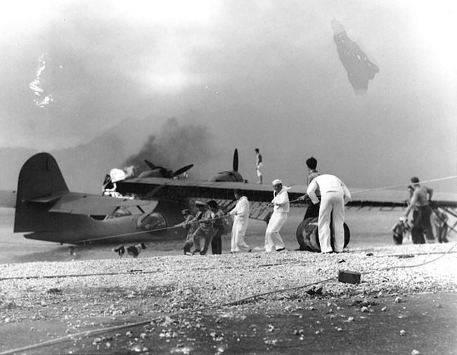 Men trying to save a burning PBY Catelina at Kaneohe.