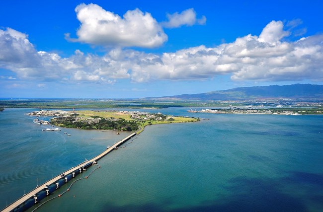 A modern-day aerial view of Pearl Harbor, including Ford Island and Battleship Row.