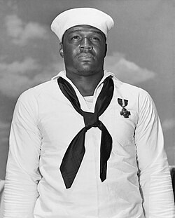 A black and white photo of Miller in Navy whites.