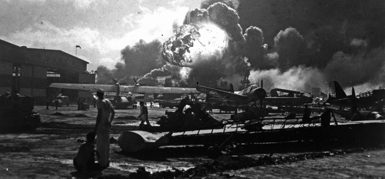 Sailors watch from Ford Island as the USS Shaw explodes.