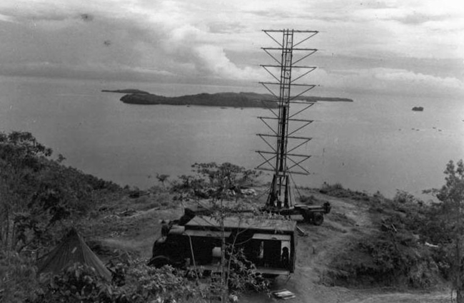 Black and white photo of a metal frame radio tower