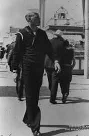 Delbert Anderson, a young male sailor, is walking along the street.
