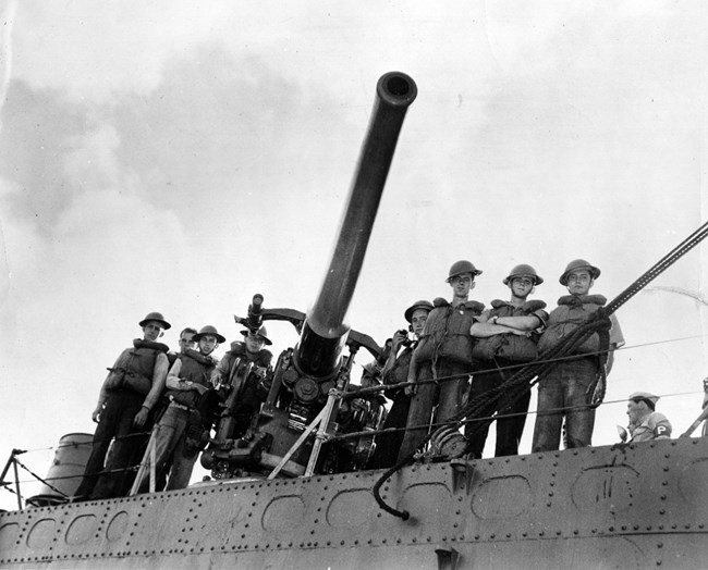 A black and white photo of soldiers on a ship