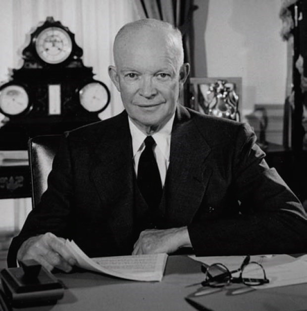 President Eisenhower sits at a desk. President Eisenhower sits at a desk.