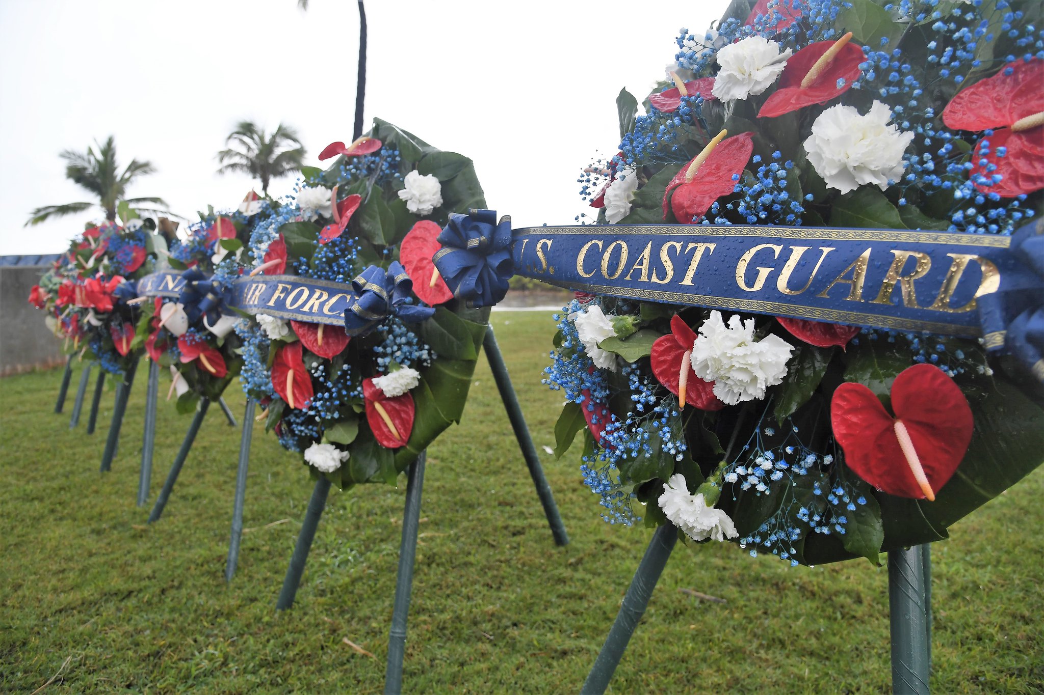 A close up image of a green wreath, with a  banner that says U.S. Coast Guard
