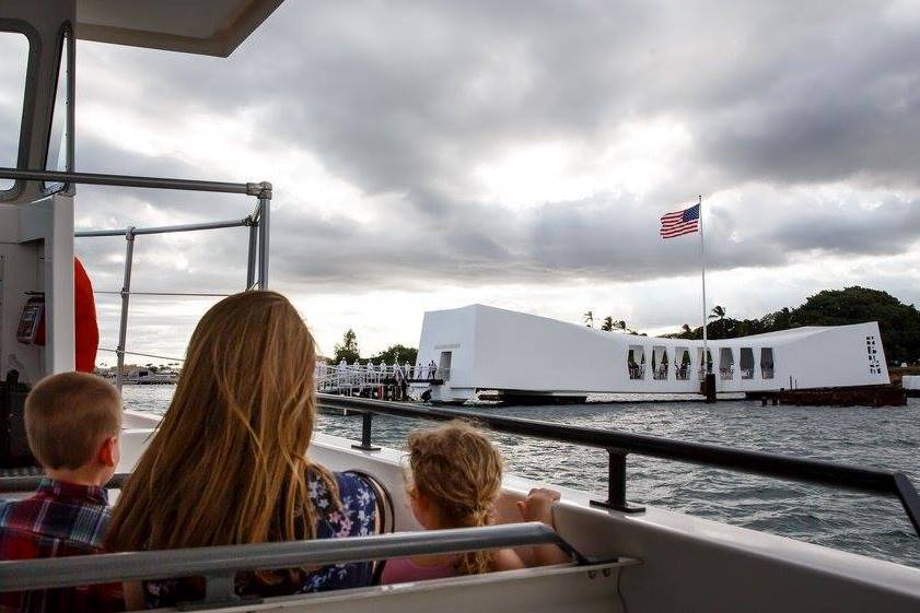 Granddaughter of Raymond Haerry travels to the USS Arizona Memorial with her two children. Woman and two children travel on one of the boats to the USS Arizona Memorial